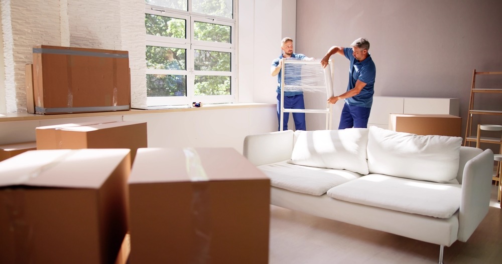 Movers carrying furniture up a staircase.